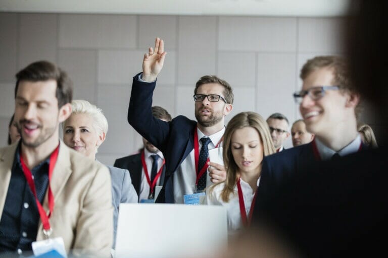 Businessman asking questions during seminar